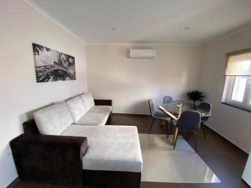 a living room with a couch and a table at Apartamentos Barbosa in Vila Nova de Foz Coa