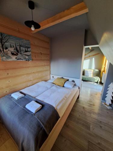 a bedroom with a large bed in a room at Noclegi przy Lesie in Zakopane