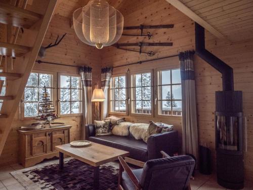 a living room with a couch in a log cabin at Chalet Chumma Galeriewohnung in Riederalp