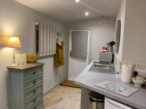 a kitchen with a sink and a counter top at Log Studio near Le Manoir aux Quat’Saisons, Oxford in Great Milton