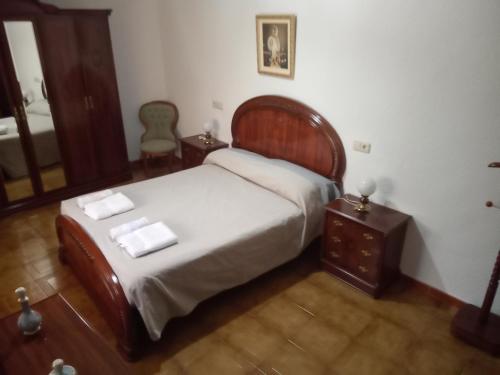 a bedroom with a bed and a table and a mirror at Miguel y Rosa Lúcar in Lúcar