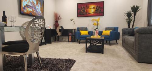 a living room with couches and chairs and a table at Private Lux Apartment in a new community in Fontana