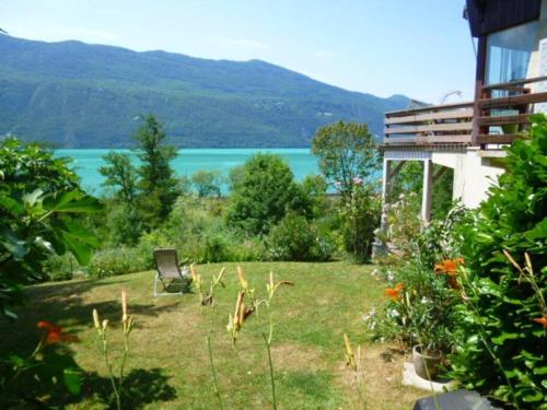 - un jardin avec vue sur une étendue d'eau dans l'établissement Meublé avec jardin au bord lac du Bourget, à Brison-Saint-Innocent