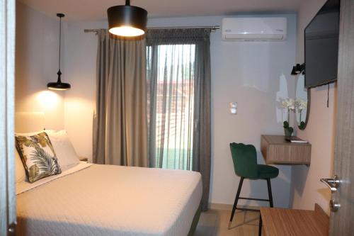 a bedroom with a bed and a desk and a chair at OLYMPUS Paradise 1 in Skotína