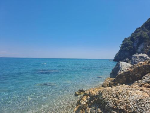 a view of the ocean from a rocky beach at OLYMPUS Paradise 1 in Skotína