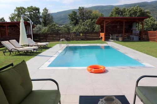 a swimming pool in the middle of a yard at OLYMPUS Paradise 2 in Skotína