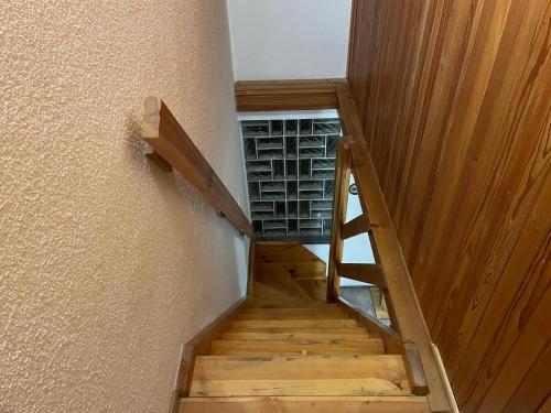 a staircase in a house with wooden floors and a wall at Chata u lesa in Bezděkov