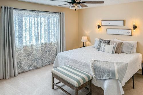 a bedroom with a bed and a large window at Royale Retreat in Branson