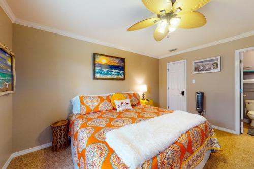 a bedroom with a bed and a ceiling fan at O'Hara Haven in Dauphin Island