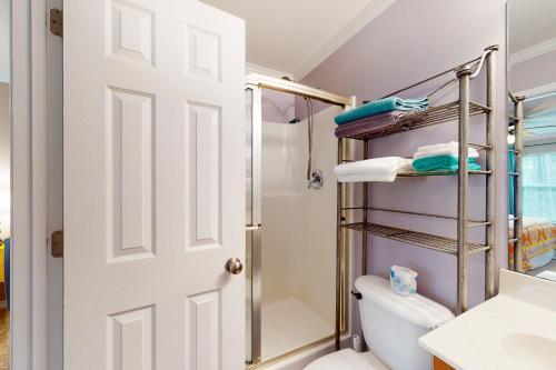a bathroom with a toilet and a shower at O'Hara Haven in Dauphin Island