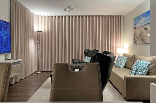 a living room with a couch and a table at Villa Deichgraf 12 "Meerblick" in Börgerende-Rethwisch