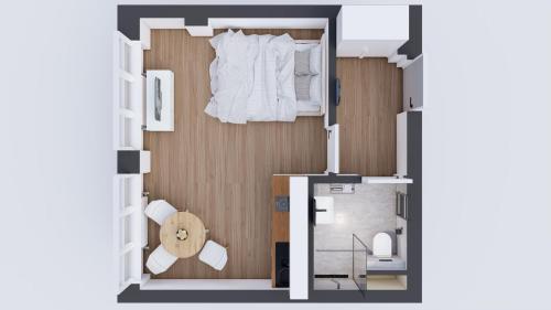 uma planta de um pequeno apartamento com uma cama em Historic Center Brno Apartment em Brno