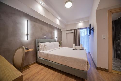 a bedroom with a large bed in a room at Anixi Hotel by AP in Athens