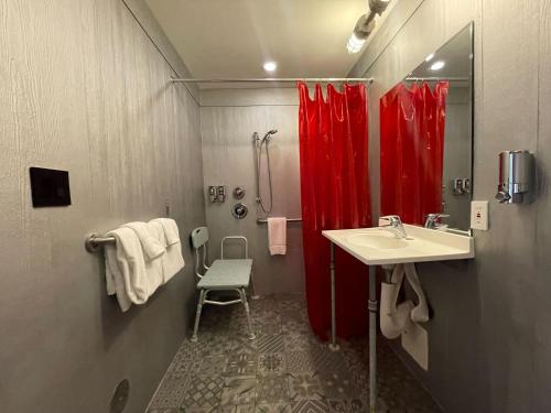 a bathroom with a red shower curtain and a sink at Hotel Gaythering - Gay Hotel - All Adults Welcome in Miami Beach