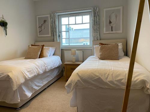 a bedroom with two beds and a window at Ferry Rd by Westcountry SA in Plymouth