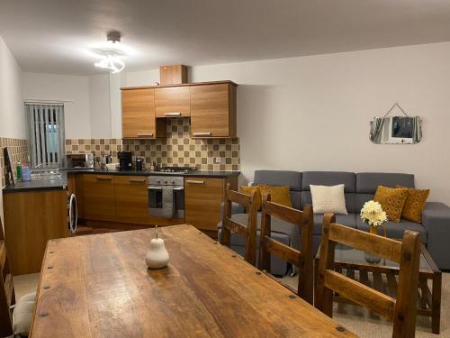 a kitchen and a living room with a wooden table at Ferry Rd by Westcountry SA in Plymouth
