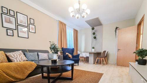 a living room with a couch and a table at Orange Onix Apartaments in Bucharest