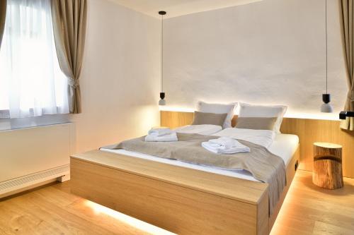 a bedroom with a bed with two towels on it at Hisa 1624 - Adults Only in Zgornja Kungota