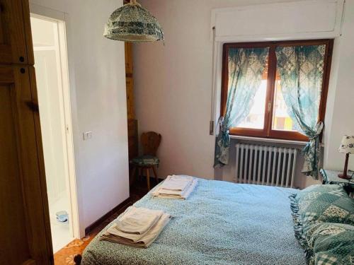 ロッカラーゾにあるAppartamento Roccarasoのベッドルーム1室(青い掛け布団、窓付)