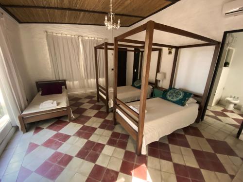 a bedroom with two bunk beds and a checkered floor at Chacra en Emprendimiento Tierra de Caballos in Colonia Estrella
