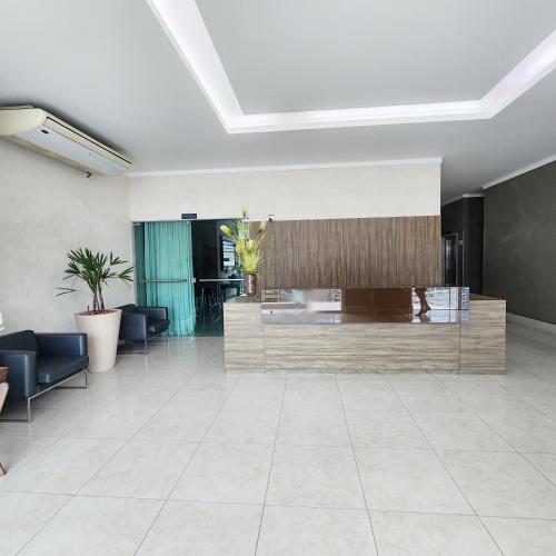 a lobby with a reception desk in a building at Atlantis Residence in Vitória