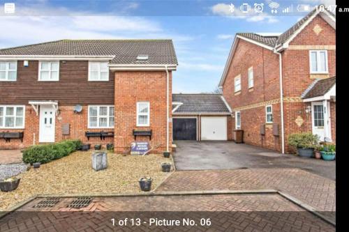 a large brick house with a large driveway at Ideally located contemporary 3 bed spacious house in Wainscot