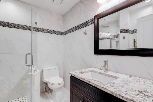 a bathroom with a toilet and a sink and a mirror at HH Beach & Tennis 226C in Hilton Head Island