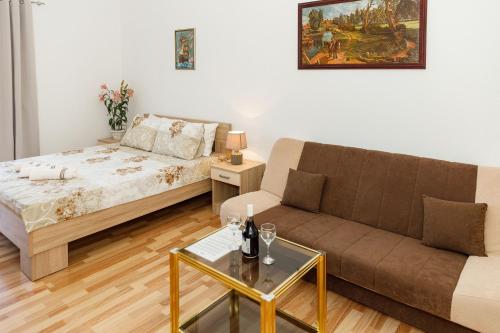 a living room with a couch and a table at Vila Nikezić in Sutomore