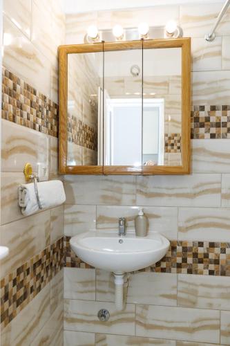 a bathroom with a sink and a mirror at Vila Nikezić in Sutomore