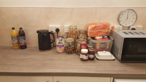 a counter top with food and a microwave at Perfect for Large Family & Friends, Free Parking, Games in Reading