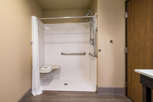 a bathroom with a shower with a shower curtain at Best Western Golden Spike Inn & Suites in Hill City