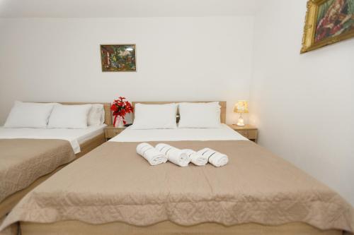 two towels on a bed in a room at Vila Nikezić in Sutomore