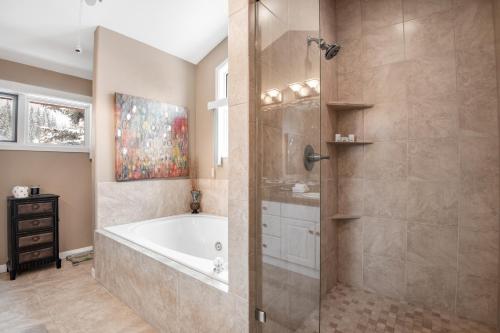 a bathroom with a tub and a shower stall at The Gem of Vail in Vail