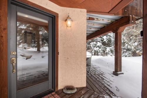 a door to a porch with snow on the ground at The Gem of Vail in Vail