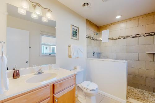 a white bathroom with a sink and a toilet at Rehoboth Beach Anna B St in Rehoboth Beach