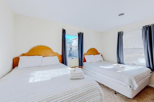 two beds in a room with two windows at Rehoboth Beach Anna B St in Rehoboth Beach