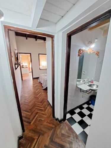a hallway with a bathroom with a sink and a mirror at Apartment Salta 4 pax in Salta