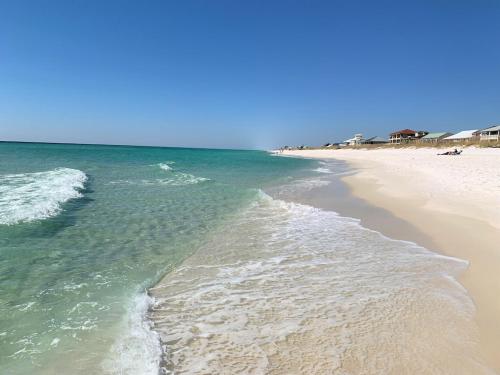 a beach with the ocean and the shoreline at New! Close To Beach, Cozy, New beds & Family Friendly in Navarre
