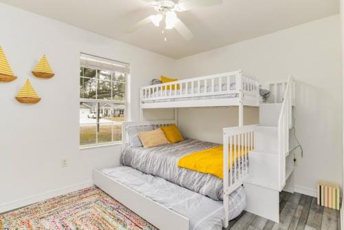 a white bedroom with a bunk bed and a ladder at New! Close To Beach, Cozy, New beds & Family Friendly in Navarre