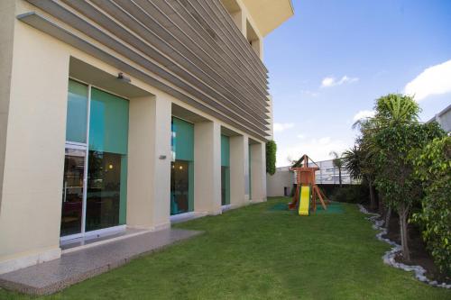 a view of the courtyard of a building with a playground at Fiesta Inn Ecatepec in Mexico City