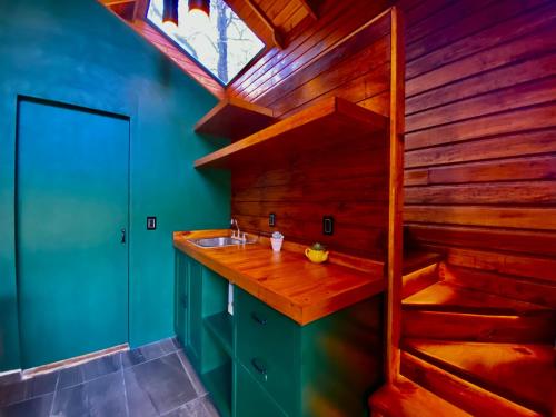 a bathroom with a sink and a wooden wall at Casa Alfeñique in Villa del Carbón