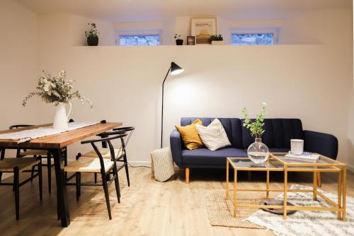 a living room with a blue couch and a table at The Maple House in Seattle