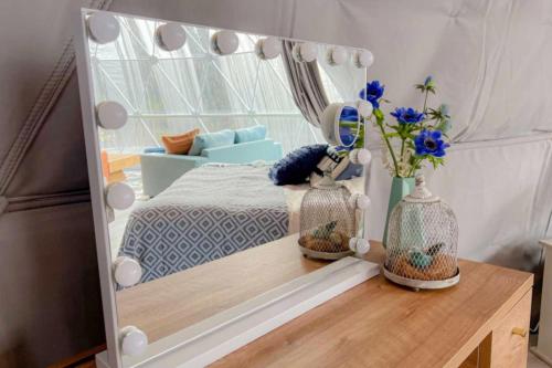 a mirror on a wooden table in a bedroom at ファームグランピング　ル・クロ　かいづか　いぶきヴィレッジ in Kaizuka