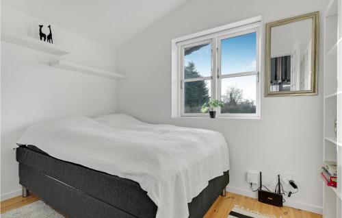 a white bedroom with a bed and two windows at Awesome Home In lsted With Wifi And 1 Bedrooms in Ølsted