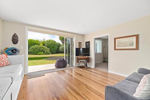 a living room with a couch and a television at Great Lake Getaway - Taupo in Taupo