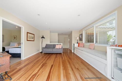 a living room with a couch and a bed at Great Lake Getaway - Taupo in Taupo