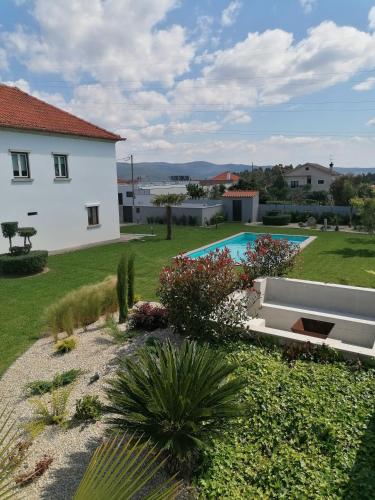a view of a house and a swimming pool at Casa D'Avó Bina Alojamento Local in Viana do Castelo
