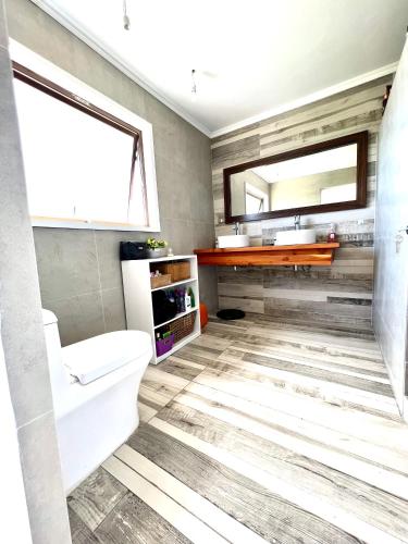 a bathroom with a toilet and a sink at Hare Mahatu in Hanga Roa