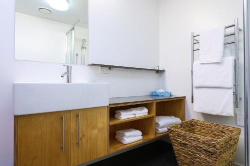 a bathroom with a sink and a counter with towels at Kaiteriteri Reserve Apartments in Kaiteriteri