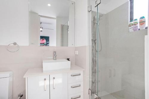 a white bathroom with a sink and a shower at 2 Welcome To Windsor 2br 2ba Pkg in Perth